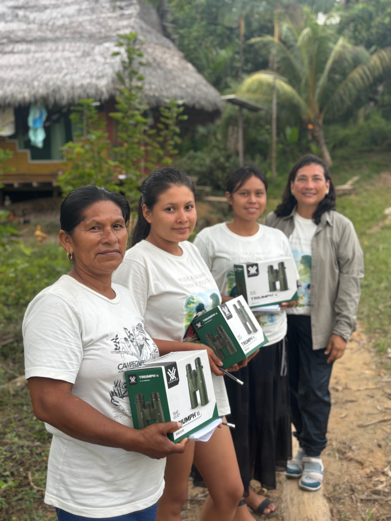 Women from Kukama communities receiving binoculars for birdwatching in the Amazon