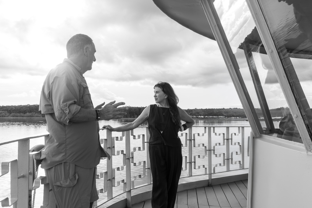 Lissy Urteaga speaking with Aldo Macchiavello on the deck of Delfín Amazon Cruises overlooking the Peruvian Amazon River