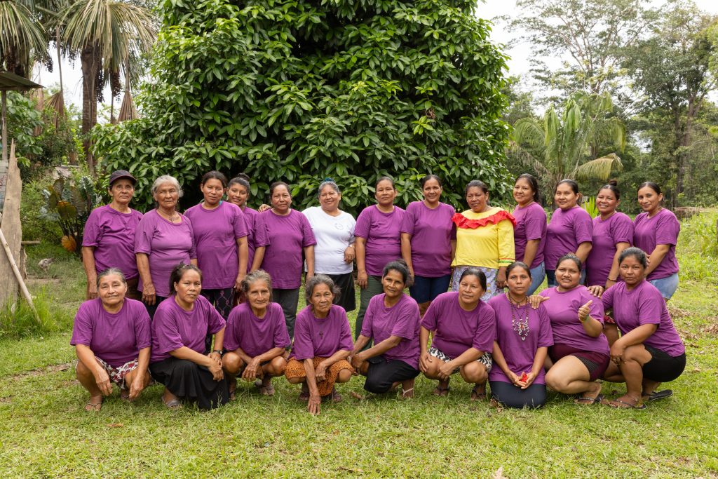 Group of Amazon women artisans standing together in a forest community in the Peruvian Amazon