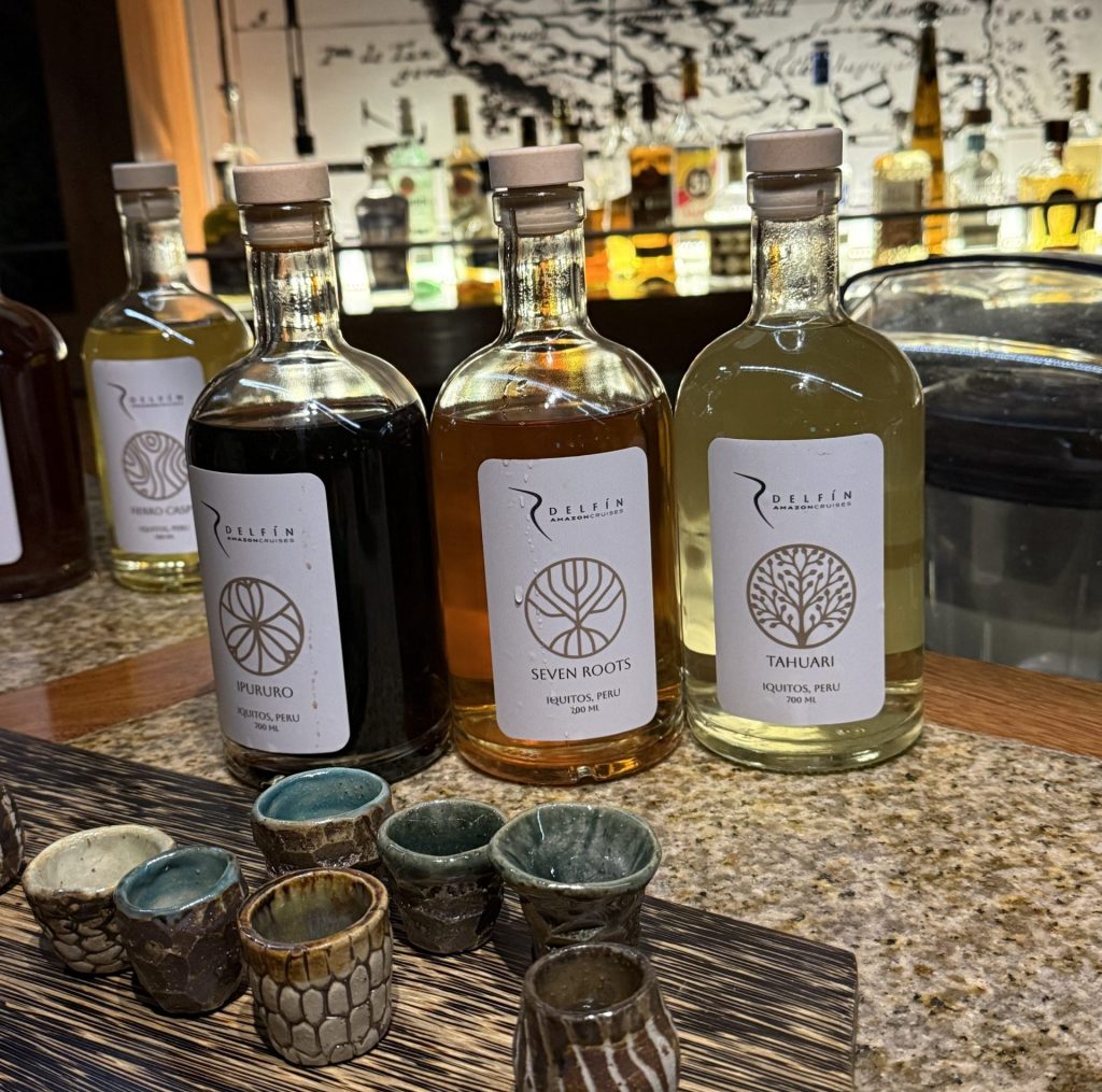Amazonian infused spirits handcrafted by Delfín Amazon Cruises displayed with tasting cups