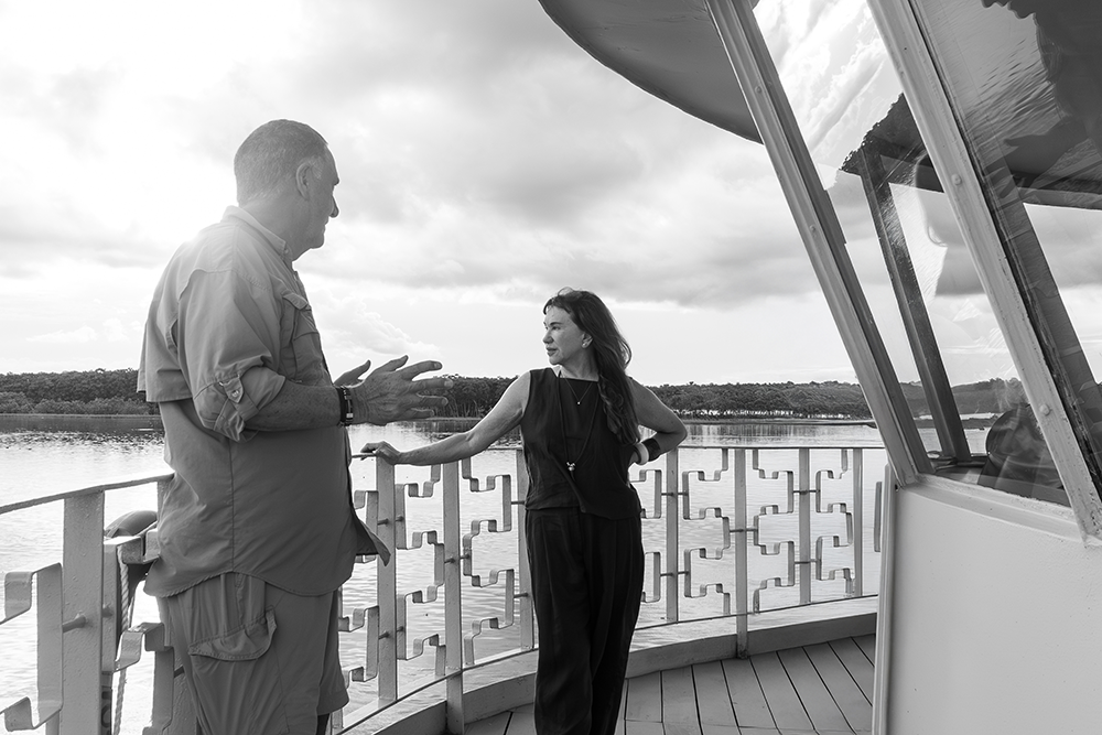 Lissy and Aldo, founders of Delfín Amazon Cruises, on deck overlooking the Amazon River