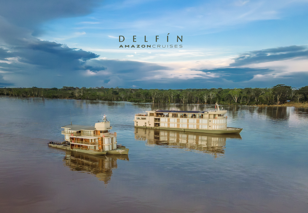Delfín Amazon Cruises vessels navigating the Amazon River surrounded by rainforest