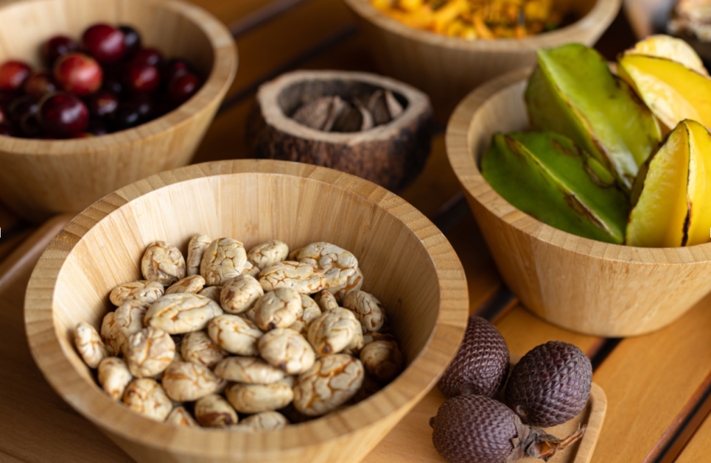 Amazonian fruits and native ingredients displayed in wooden bowls