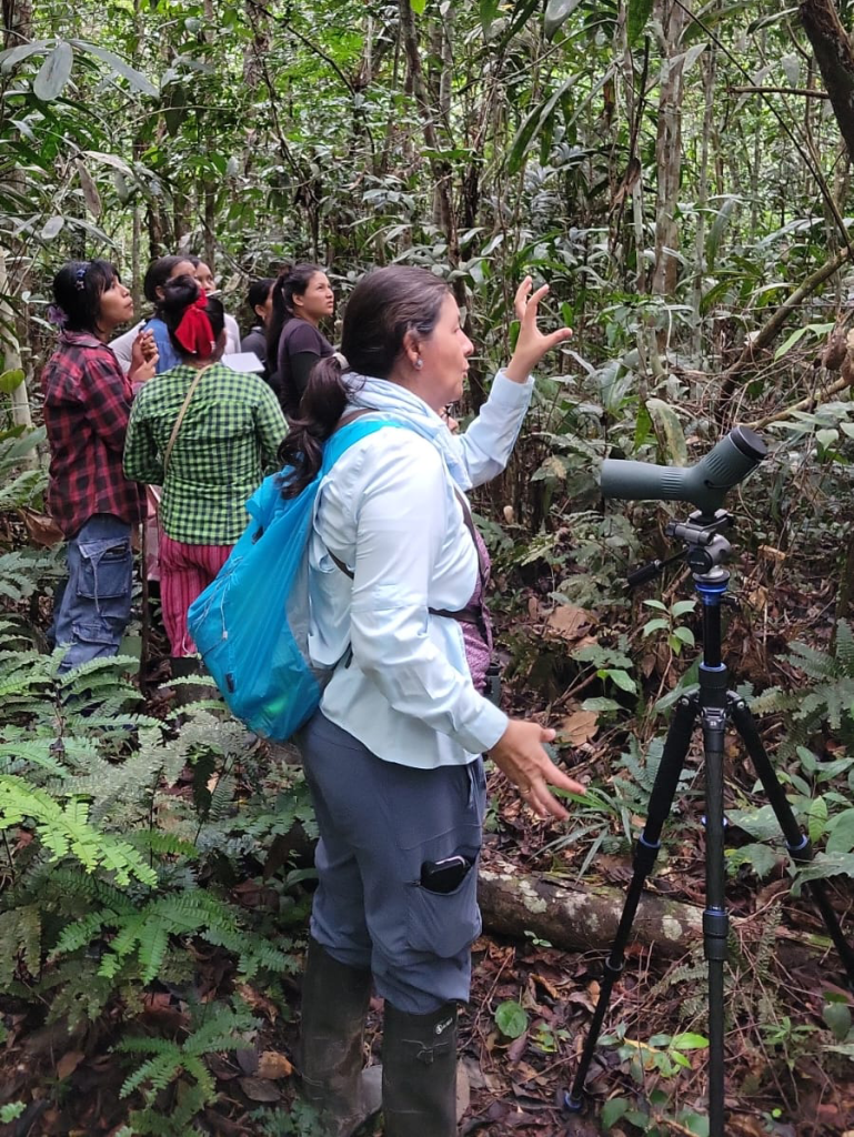Kukama women walking through the Amazon rainforest during birdwatching training