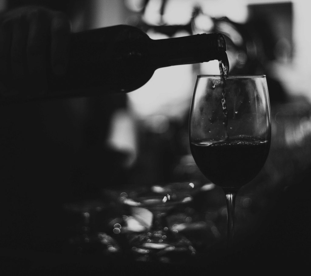 Wine being poured during a candlelit dinner aboard Delfín Amazon Cruises