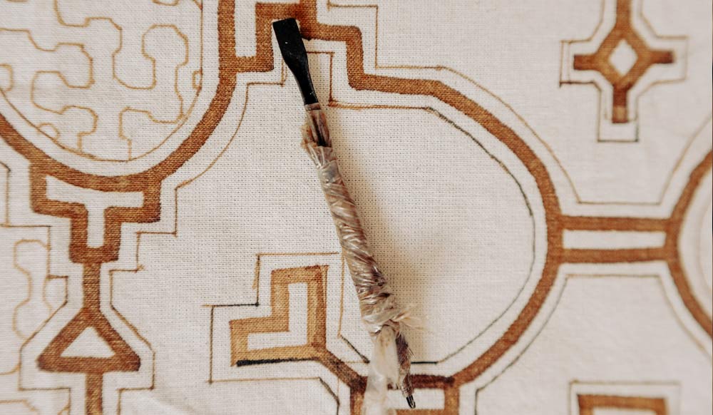 Detail of kené pattern painted on raw cotton with traditional Shipibo brush