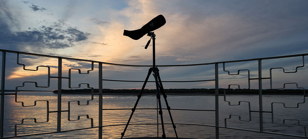 Telescope on the deck of a Delfín vessel at dusk in the Peruvian Amazon