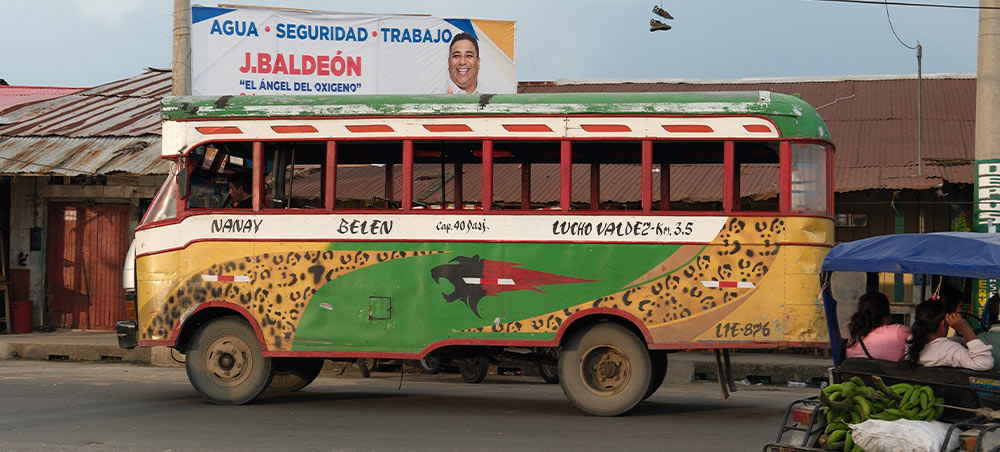 Hand-painted wooden bus traveling through Iquitos