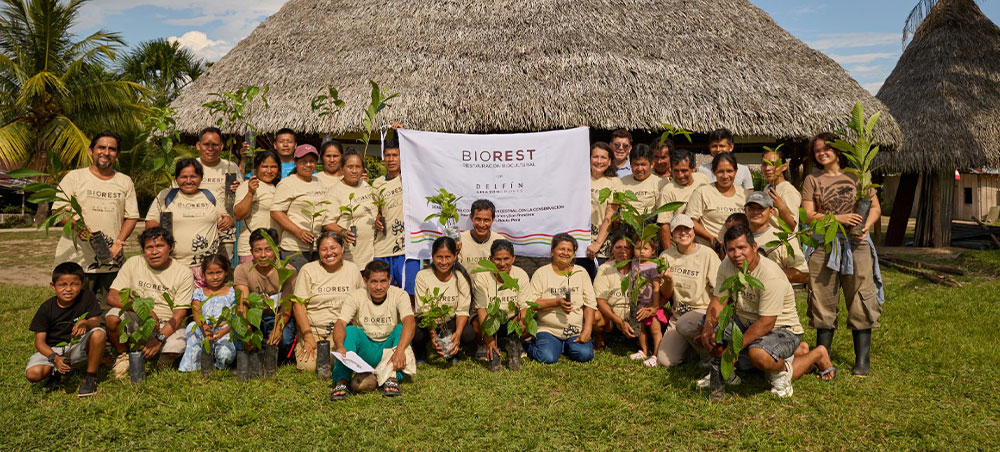 BioRest participants holding native seedlings in a Peruvian Amazon community